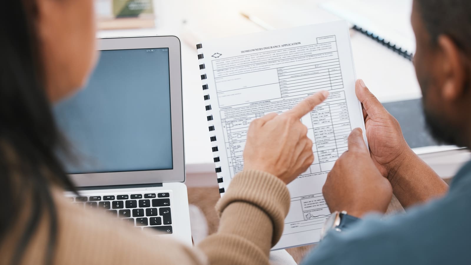 Couple reviewing property tax and insurance documents together at home
