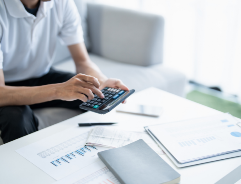 Person using calculator with documents